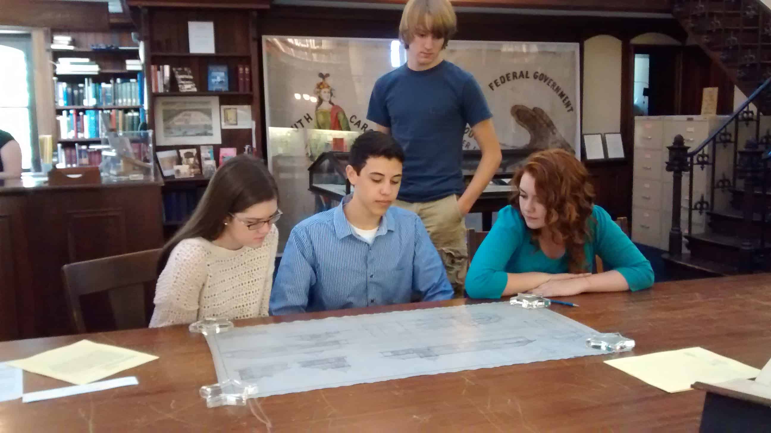High School Students Investigating Railroad Depot Blue Prints at GHS