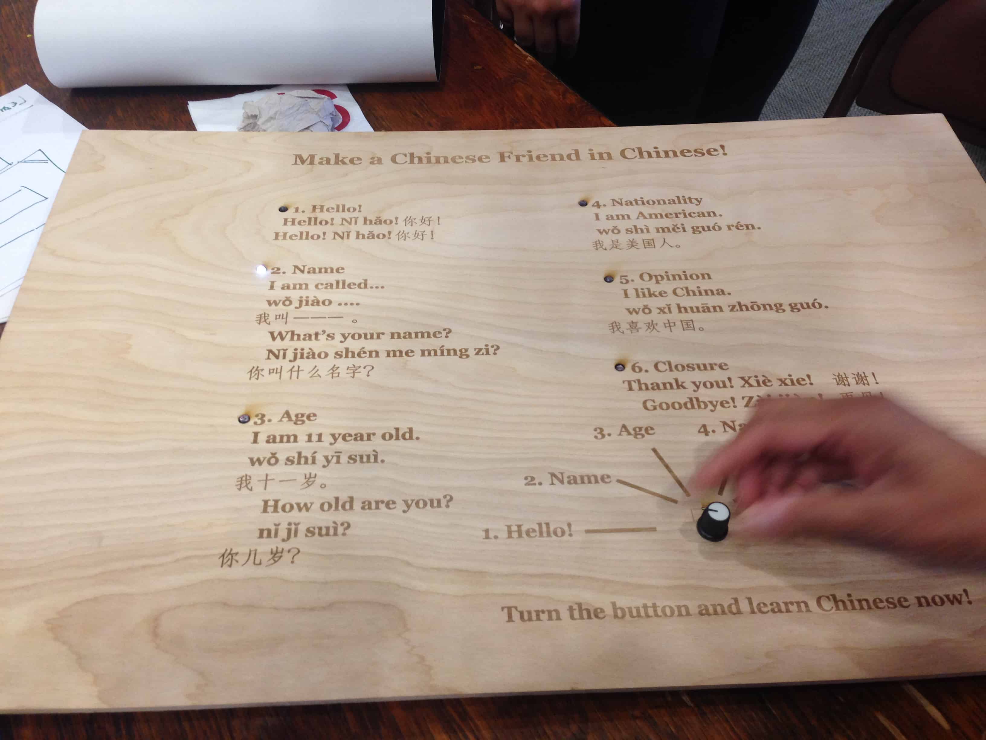 Board with English-Chinese tranlations and a knob