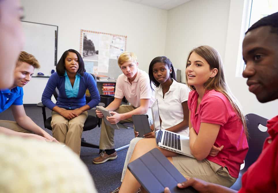 High school students talking to each other, which teaches critical thinking and empathy