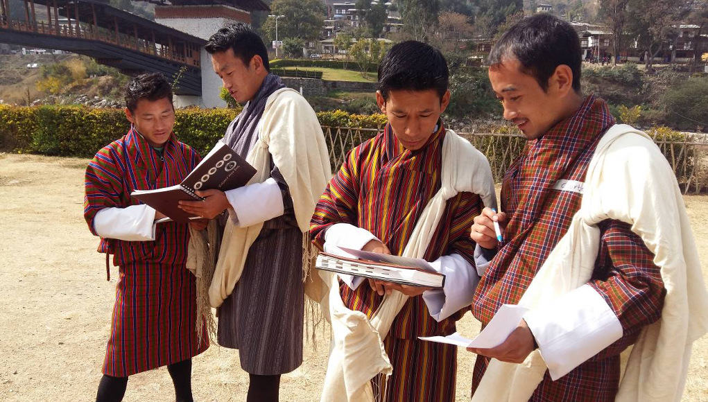 Smiling Bhutan Students reading and increasing gross national happiness