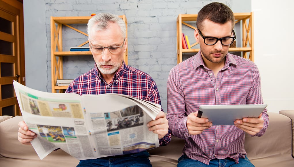 father teaching son to recognize fake news