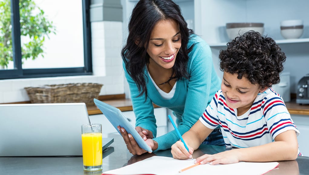 parent using tablet to help student on homework by delivering flipped learning