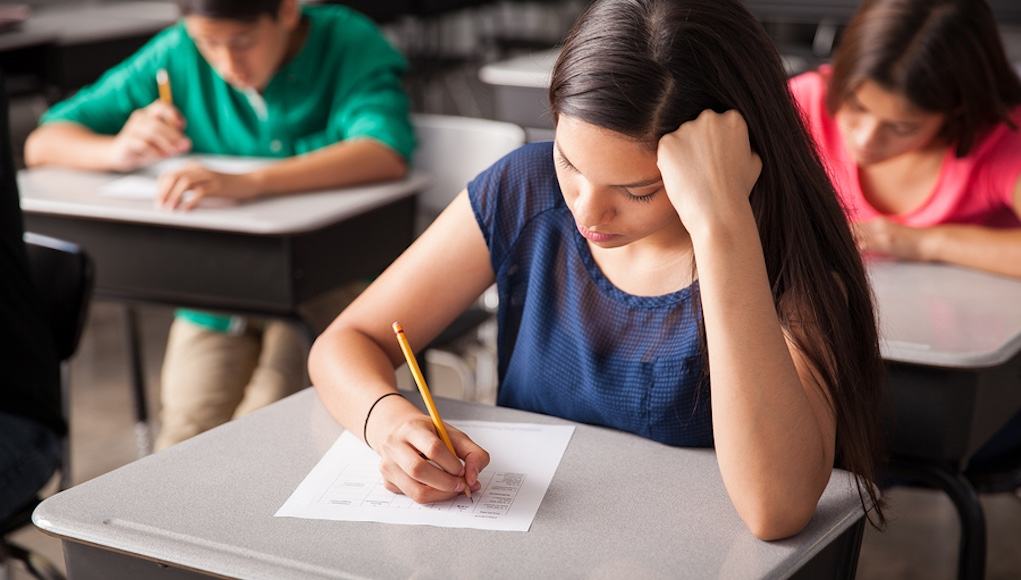 Group of high school students taking an innovative assessment in a classroom