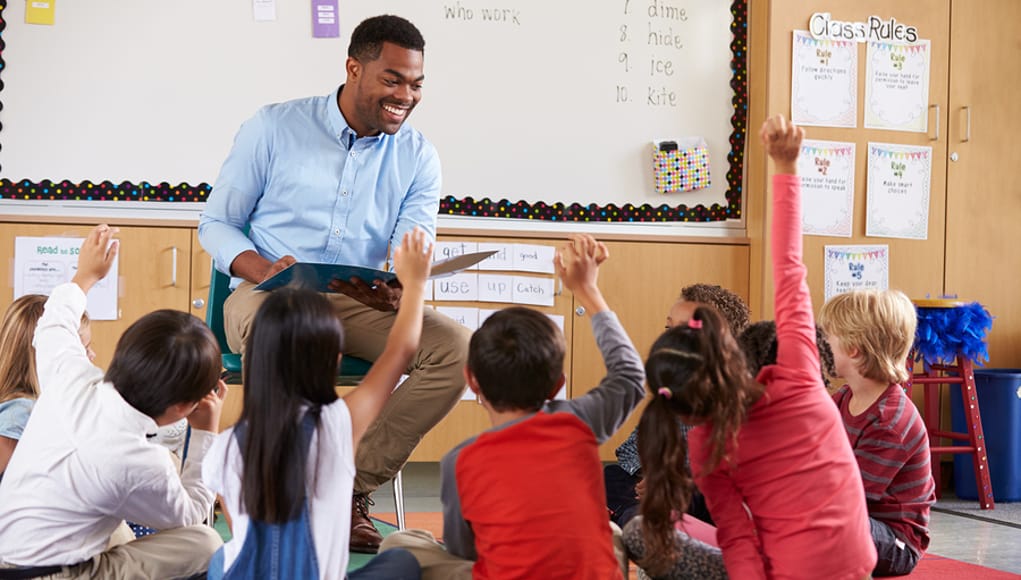 Teachers with students raising their hands