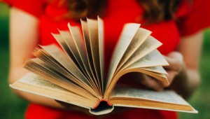 Woman flipping through pages of book for review