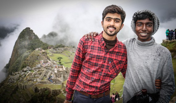 Students standing and smiling in front of Machu Picchu, a great way to take time out of the classroom