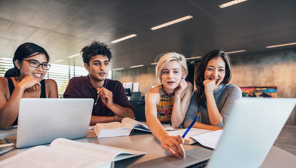 College Students using laptops to study in interconnected learning