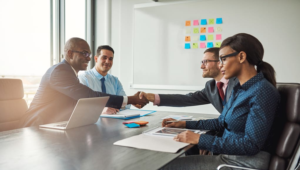 Two EdLeaders Shaking Hands in a business meeting after finishing with agreement crafting