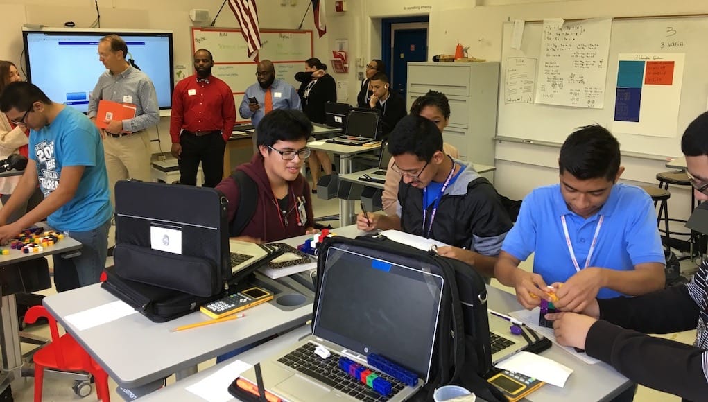 Students at energy institute high school working on laptops and tech projects in class