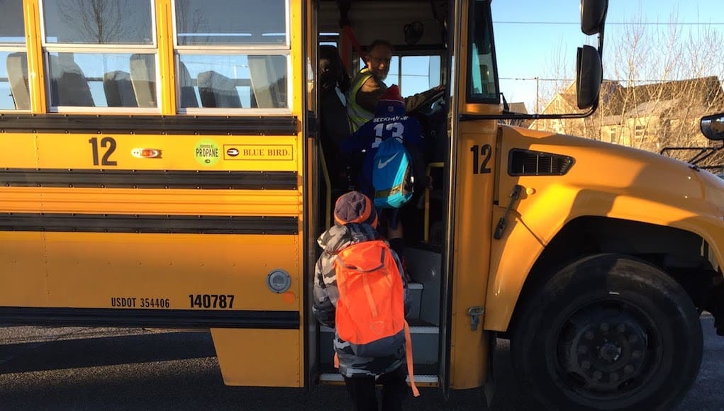 First person view of someone taking the shadow a student challenge that is following a child stepping on to school bus