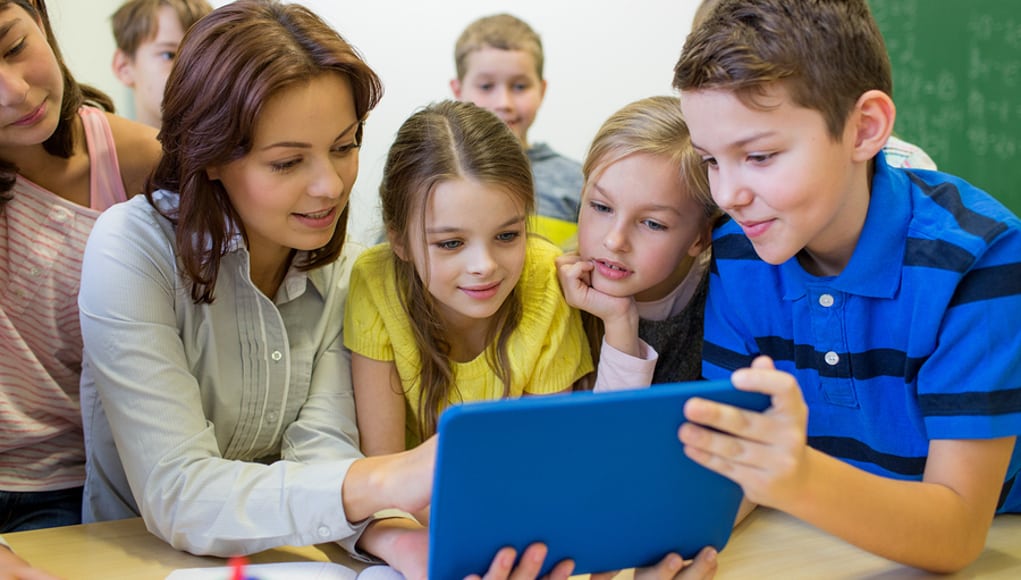 Teacher and students using edtech apps on a tablet