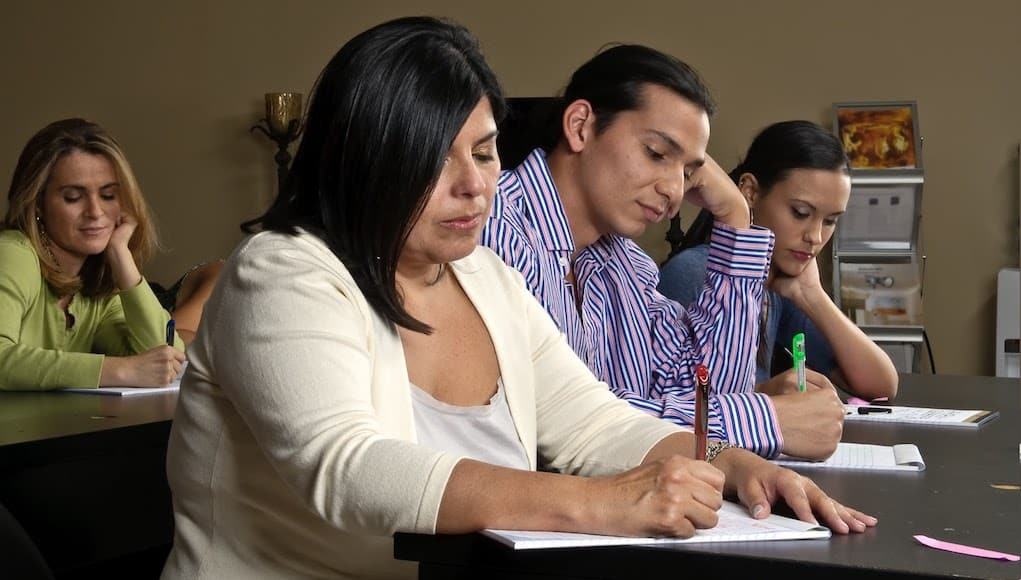 A group of post-secondary adult learners during a training class in the office.