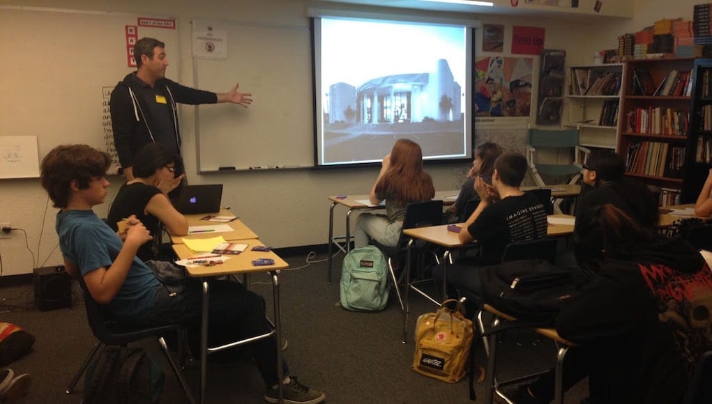 A teacher giving a lesson on city plans as an example of place-based education