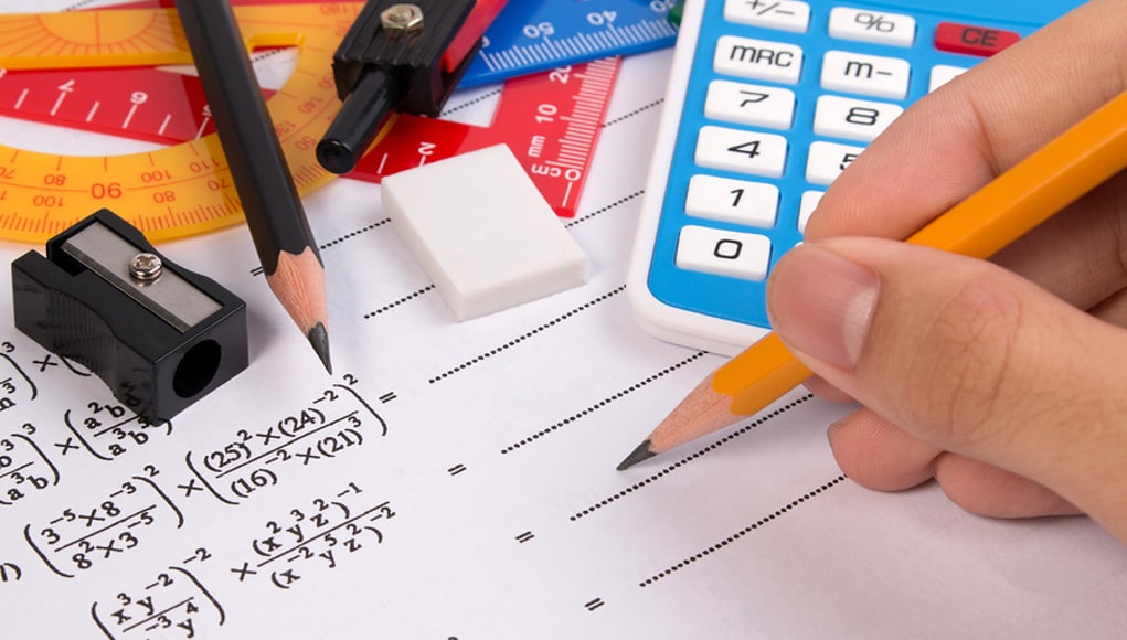 Hand Holding Pencil about to do Math Problems Feature Image