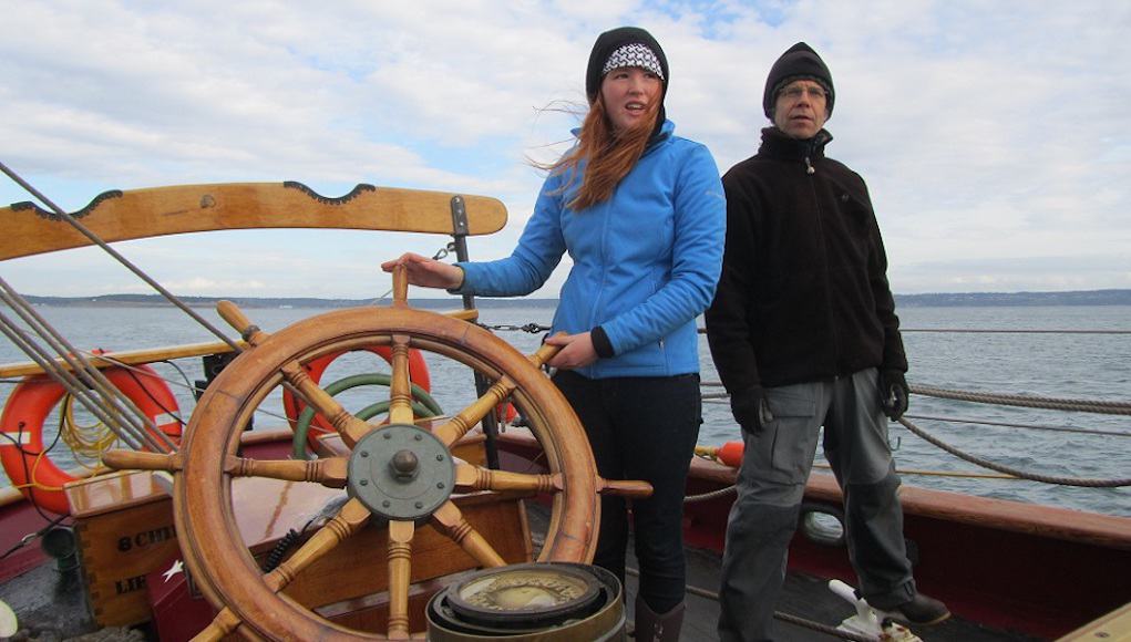 Student at the helm of a boat Place-Based Ed Feature Image