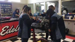 Students in an automotive shop working on an engine in santa ana unified school district