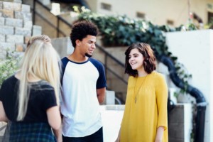 Urban high school students having a conversation.