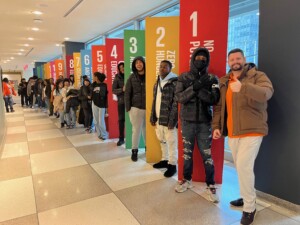 Mr. Glassie and students in front of the Sustainable Development Goals at the United Nations Headquarters in April 2023 (photo courtesy of Jay Glassie)