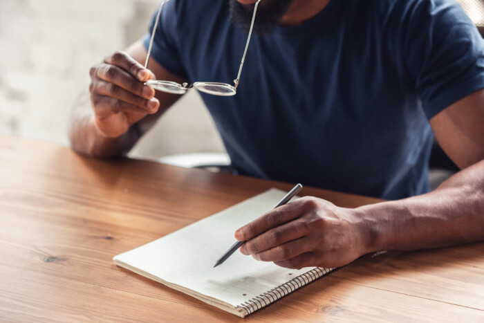 Writing. Close up of african-american male hands, working in office. Concept of business, finance, job, online shopping or sales. Copyspace for advertising. Education, communication and freelance.