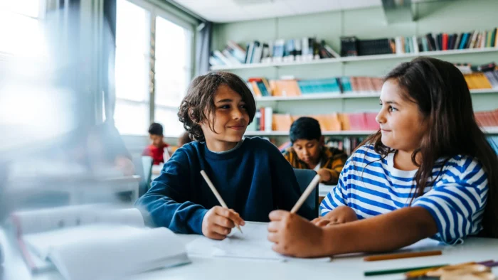 Image of two students in a classroom.