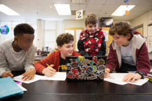 Sixth-graders work together on a science project about weather disasters.
